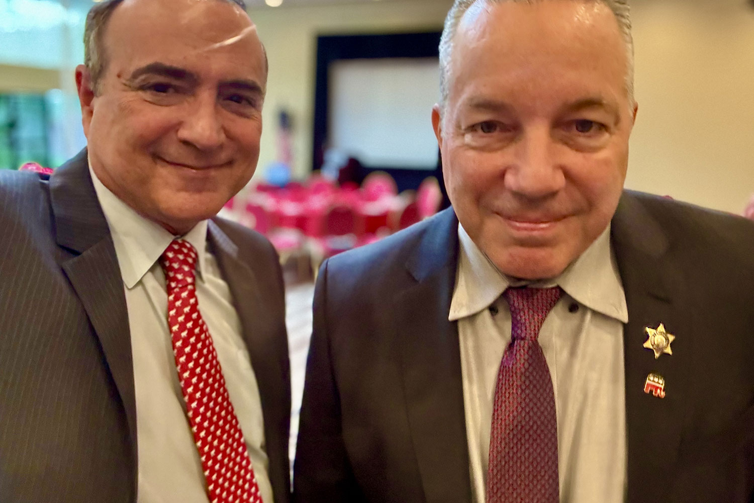 2 men wearing coal smiling