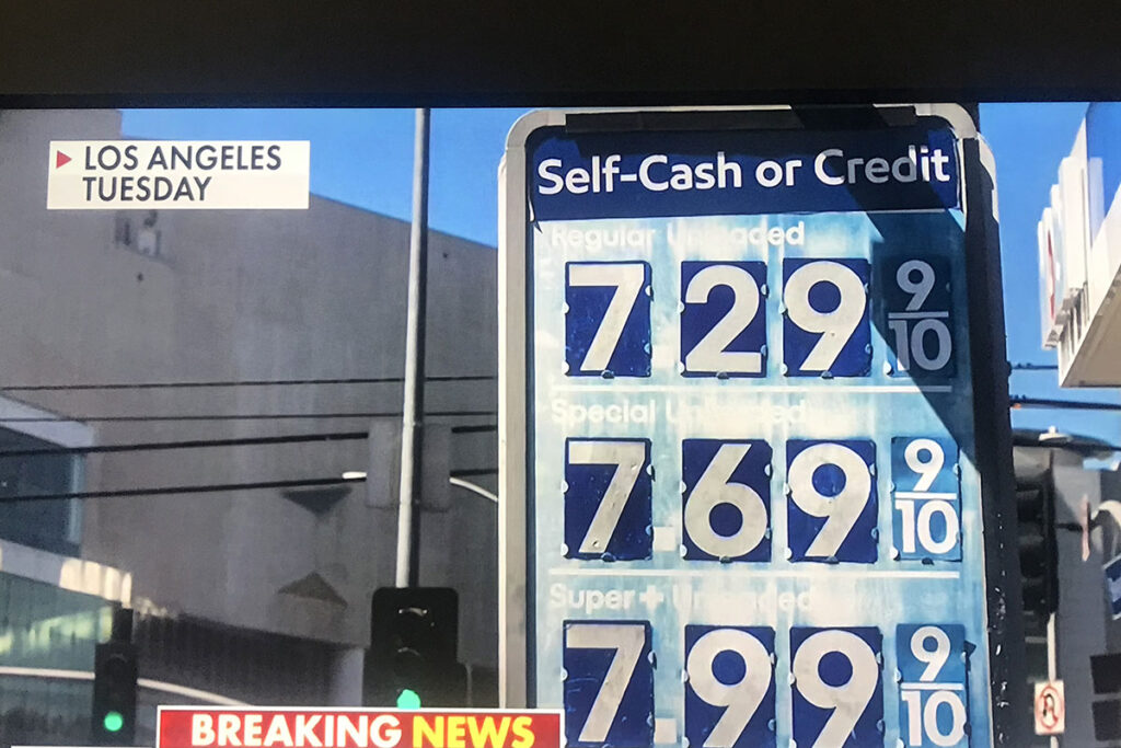 A gasoline price display board showing current fuel costs at a local gas station